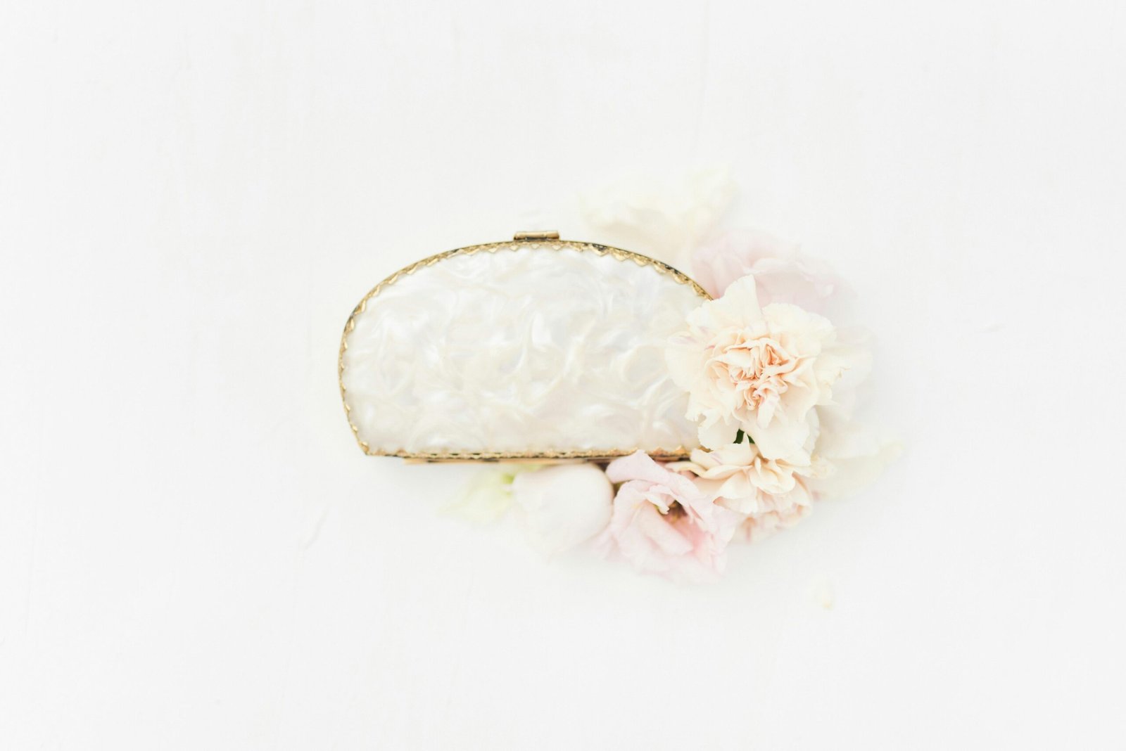 Elegant Accessory Displayed with Flowers against White Background